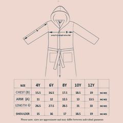 Child wearing a white hooded robe with small patterns on a white background