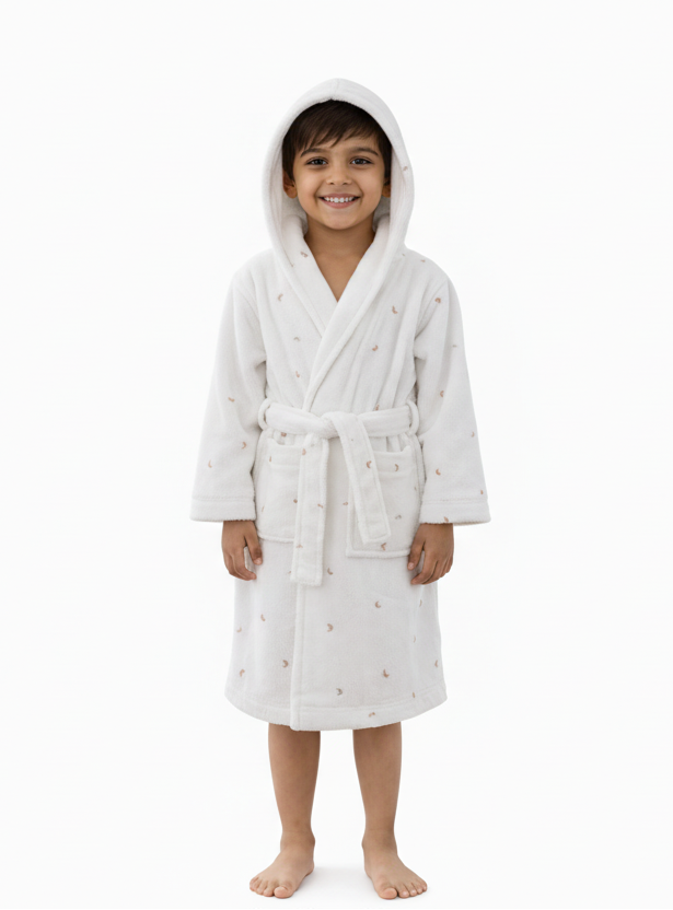 Child wearing a white hooded robe with small patterns on a white background