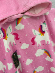 Pink fabric with unicorn and rainbow pattern, close-up view.