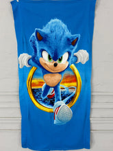Blue towel with Sonic the Hedgehog design on a wooden surface