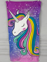 Unicorn-themed towel with colorful mane and starry background on a purple background