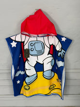 Children's hooded towel with astronaut design on a wooden surface