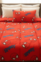 Red Spider-Man themed comforter set with matching pillows on a bed.