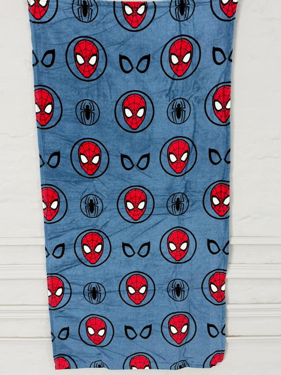 Spider-Man patterned towel on a wooden surface