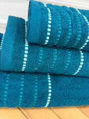 Set of blue towels with white stripes on a wooden surface