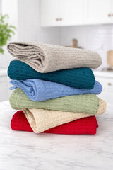 Stack of folded colorful towels on a white surface