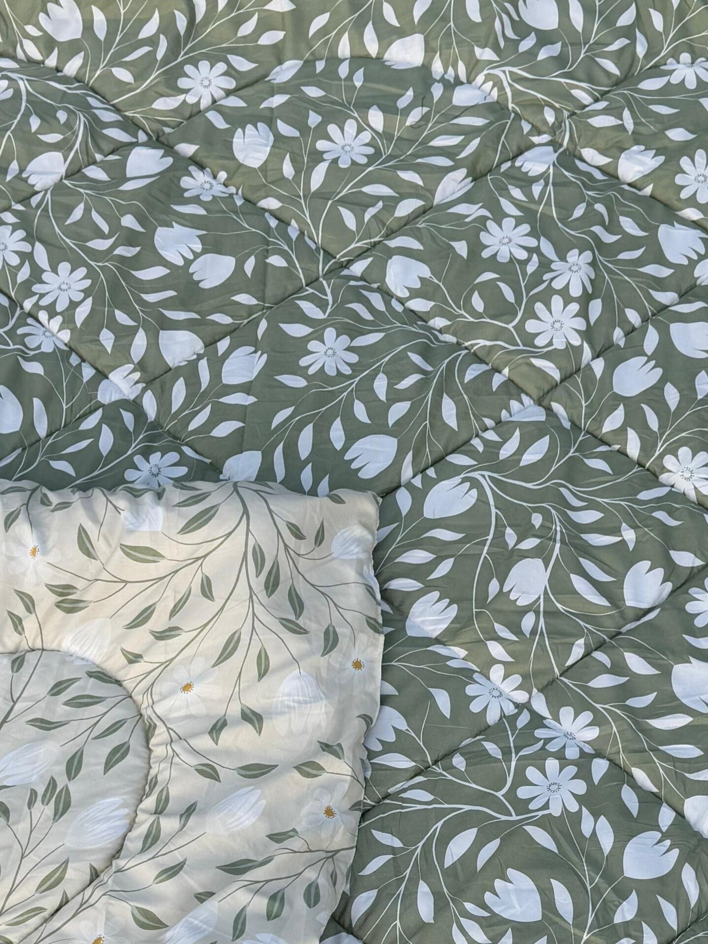 Floral patterned fabric with white flowers on a green background