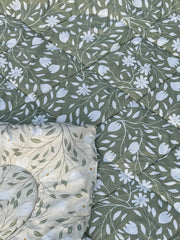 Floral patterned fabric with white flowers on a green background