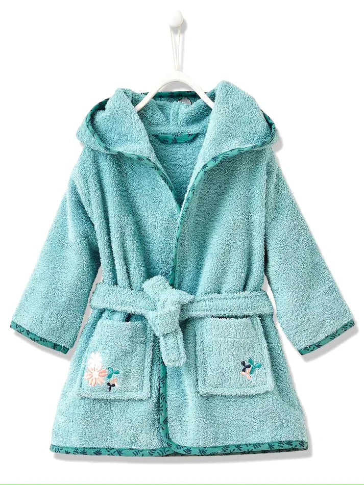 Child wearing a teal hooded robe with a cartoon character on a white background
