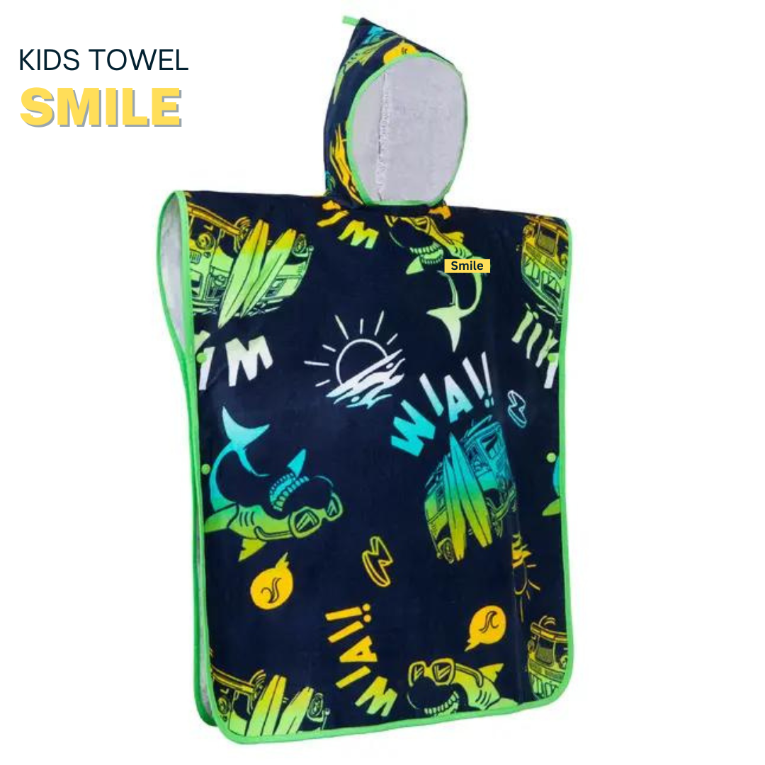 Child wearing a dark blue poncho with colorful dinosaur prints in a bright room.