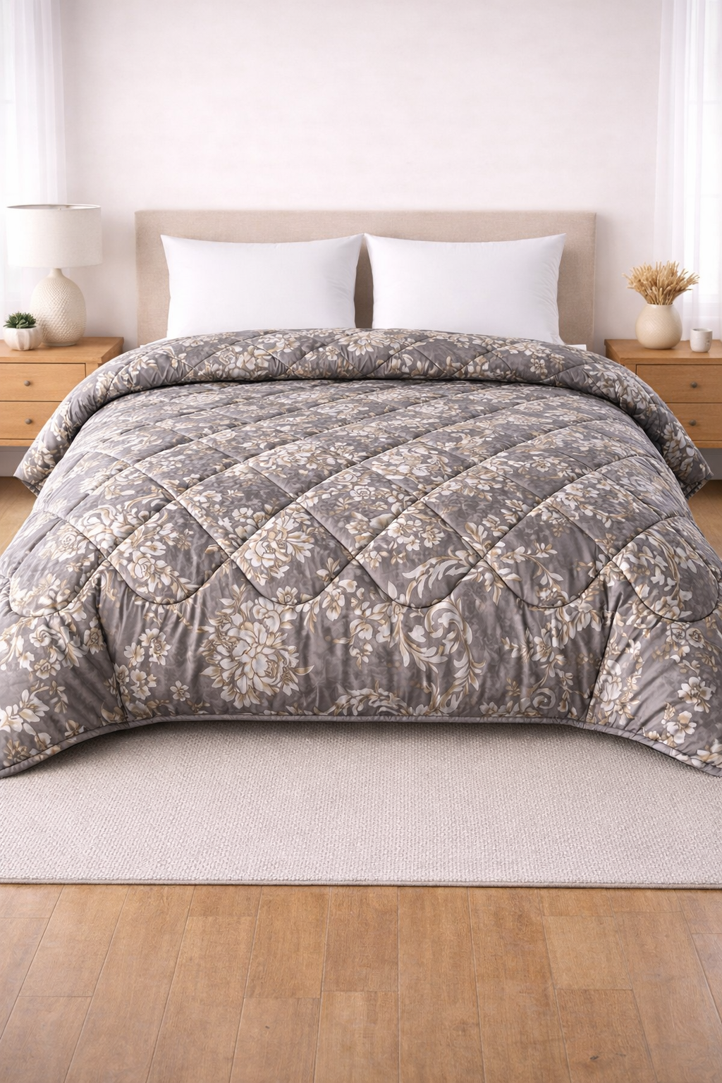 Gray quilted comforter on a bed with white pillows in a bedroom setting.