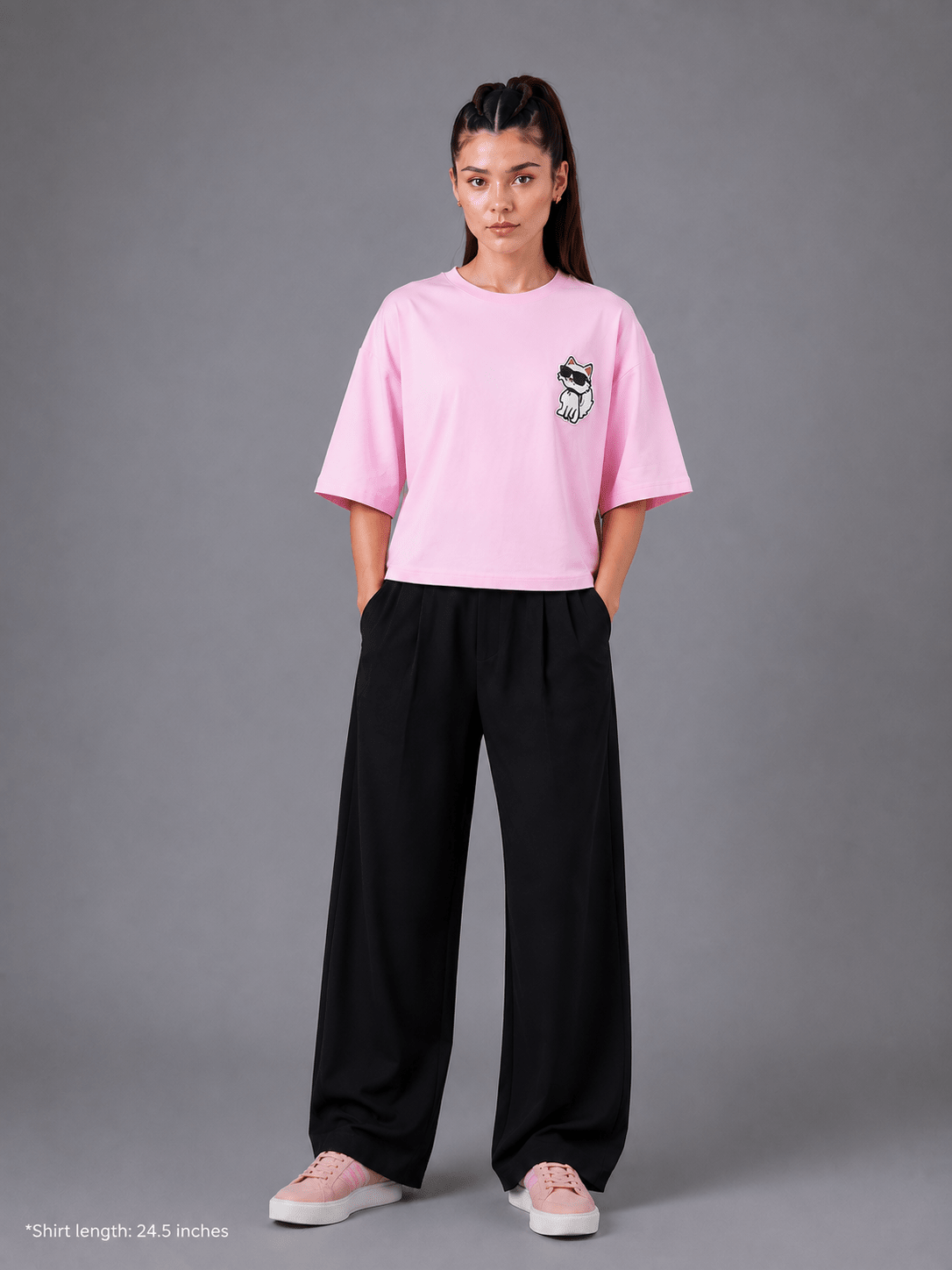 Person wearing a pink t-shirt and black pants on a gray background