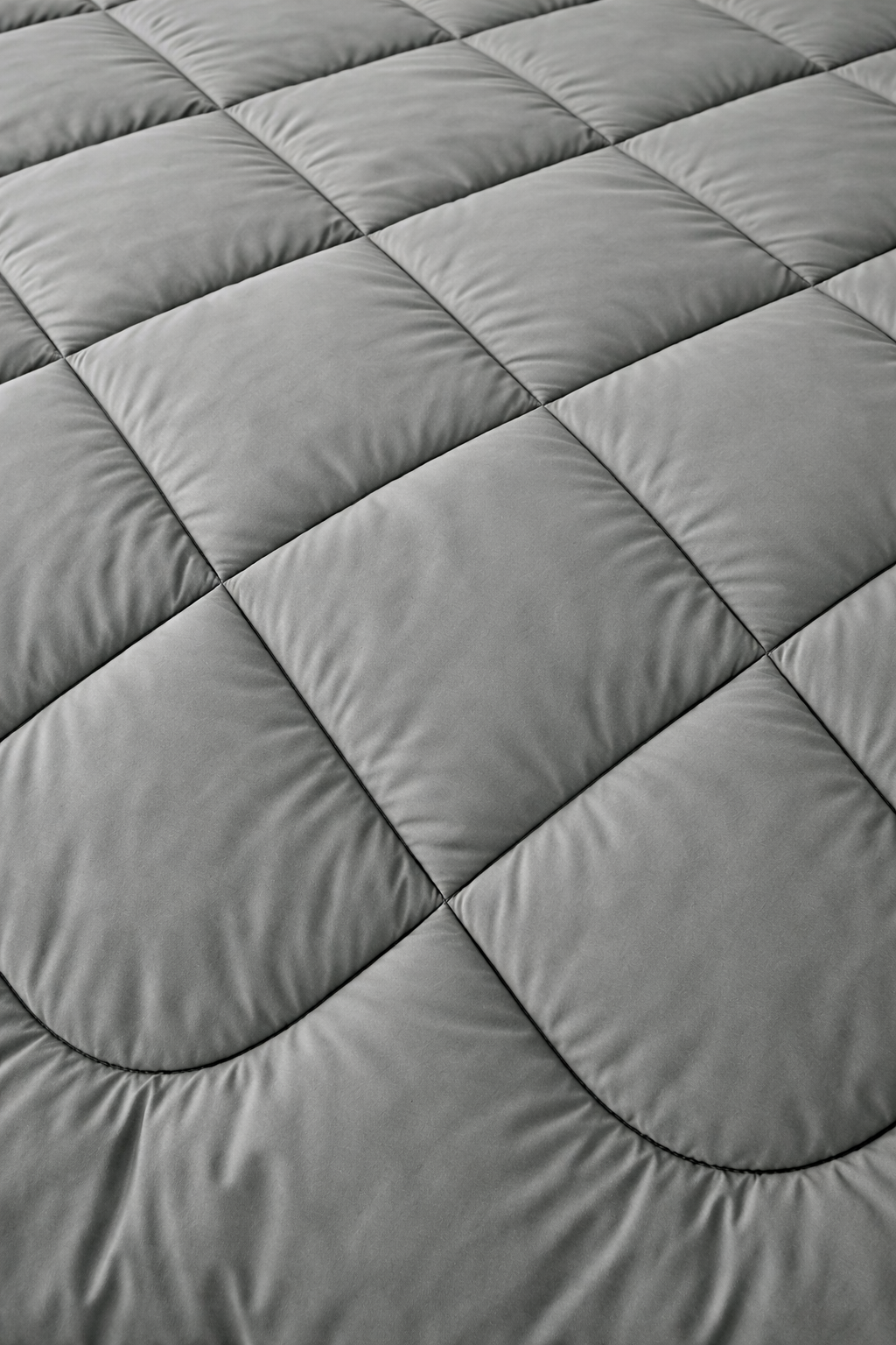 Gray quilted mattress pad with diamond pattern