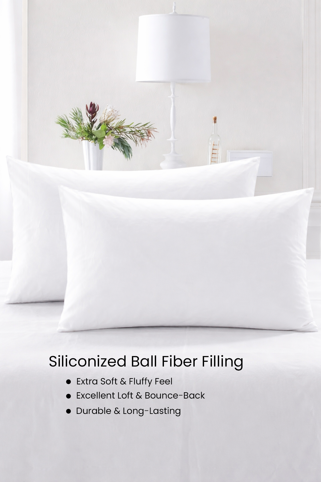 White pillows on a bed with decorative elements in the background, featuring text about siliconized ball fiber filling.