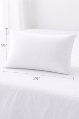 White pillow on a white background with measurements indicated