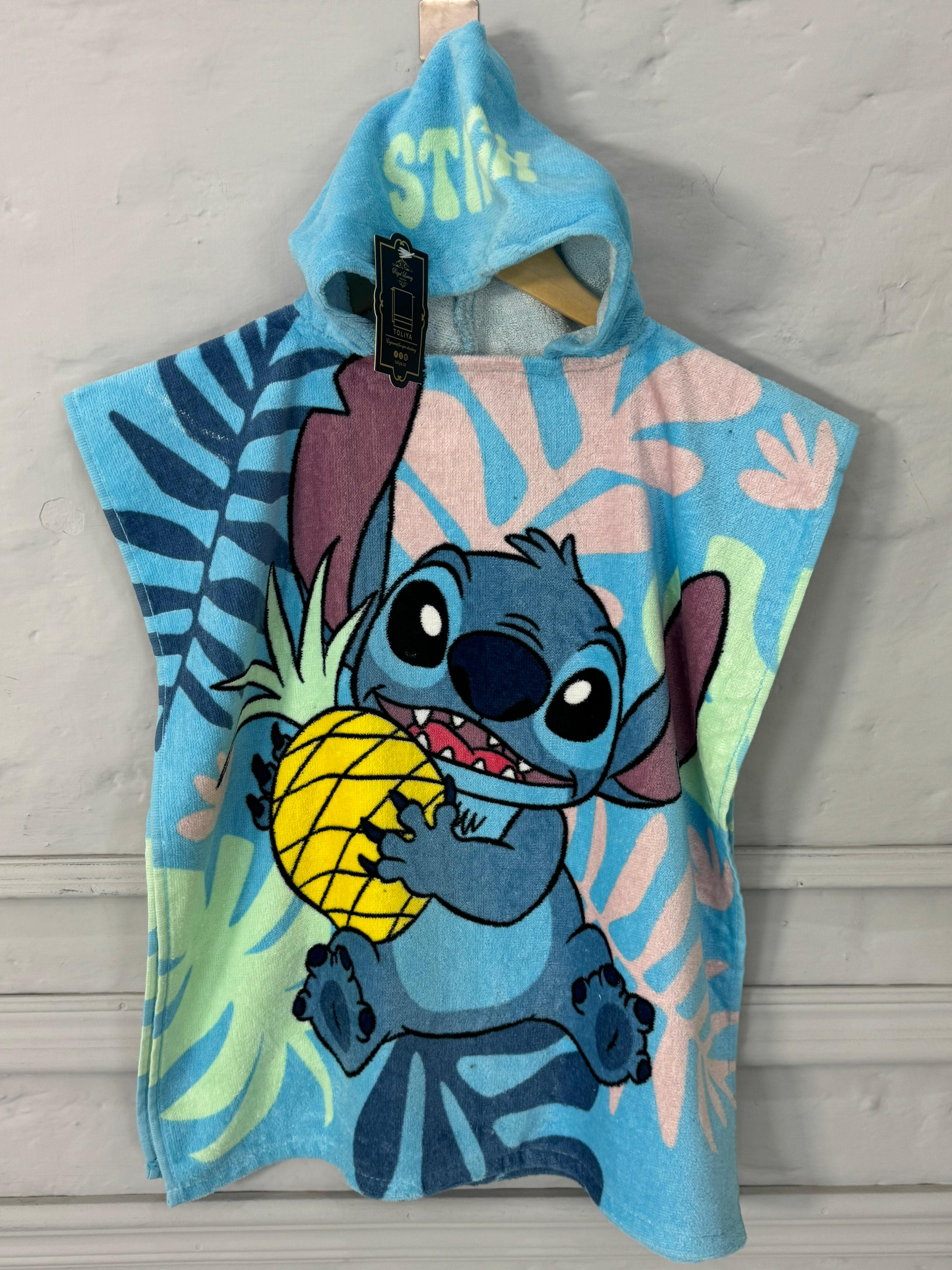 Children's hooded towel with cartoon character holding a pineapple on a light gray background