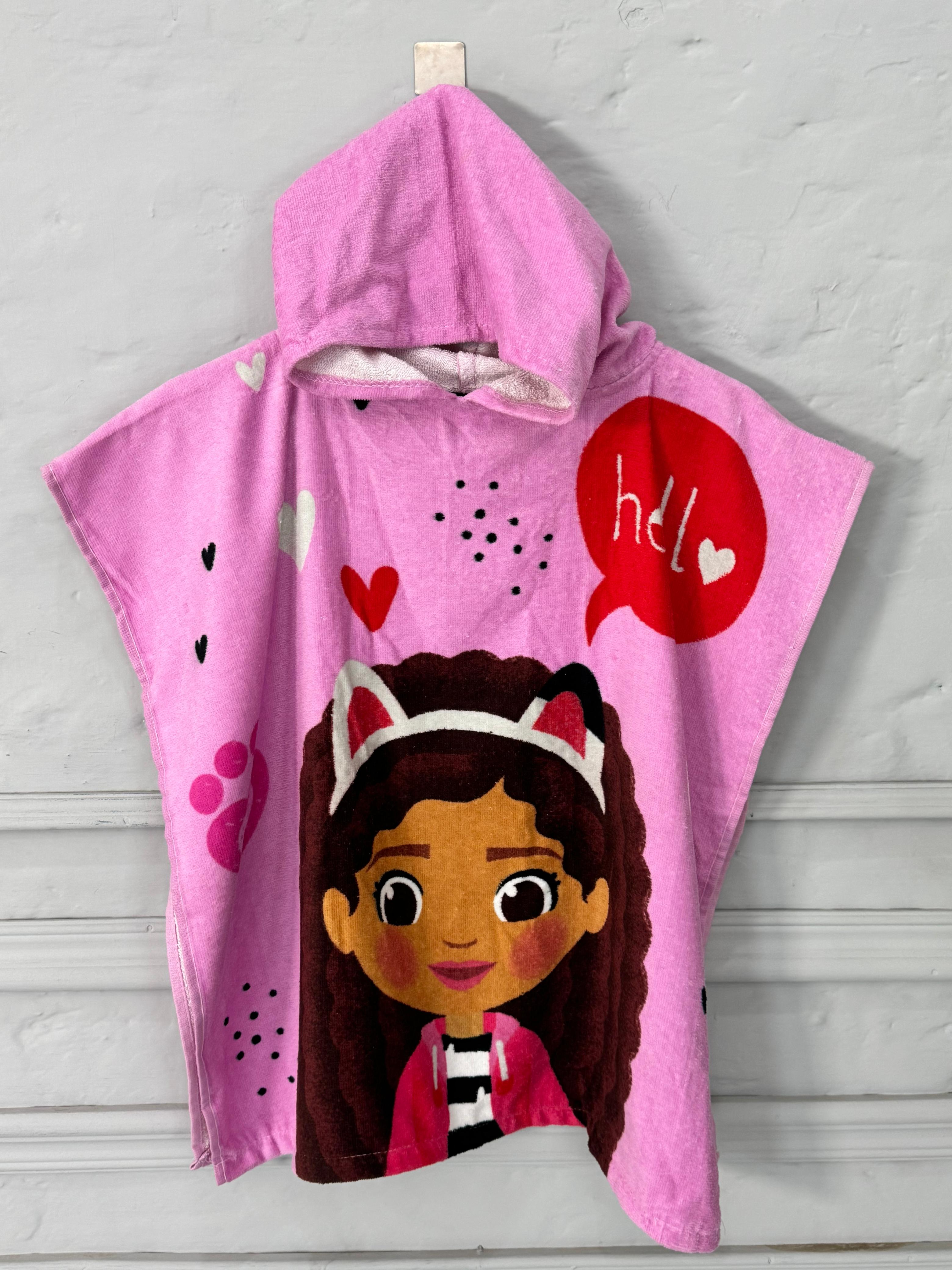 Pink hooded towel with cartoon character and text on a gray background