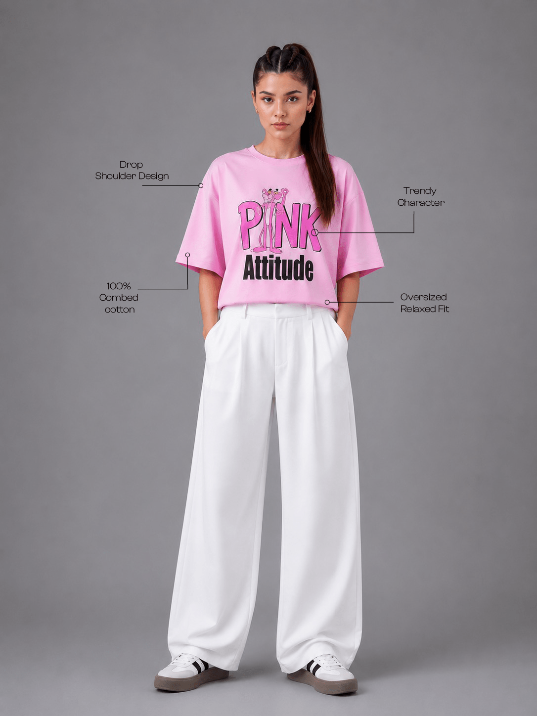 Person wearing a pink t-shirt with text and white pants on a gray background