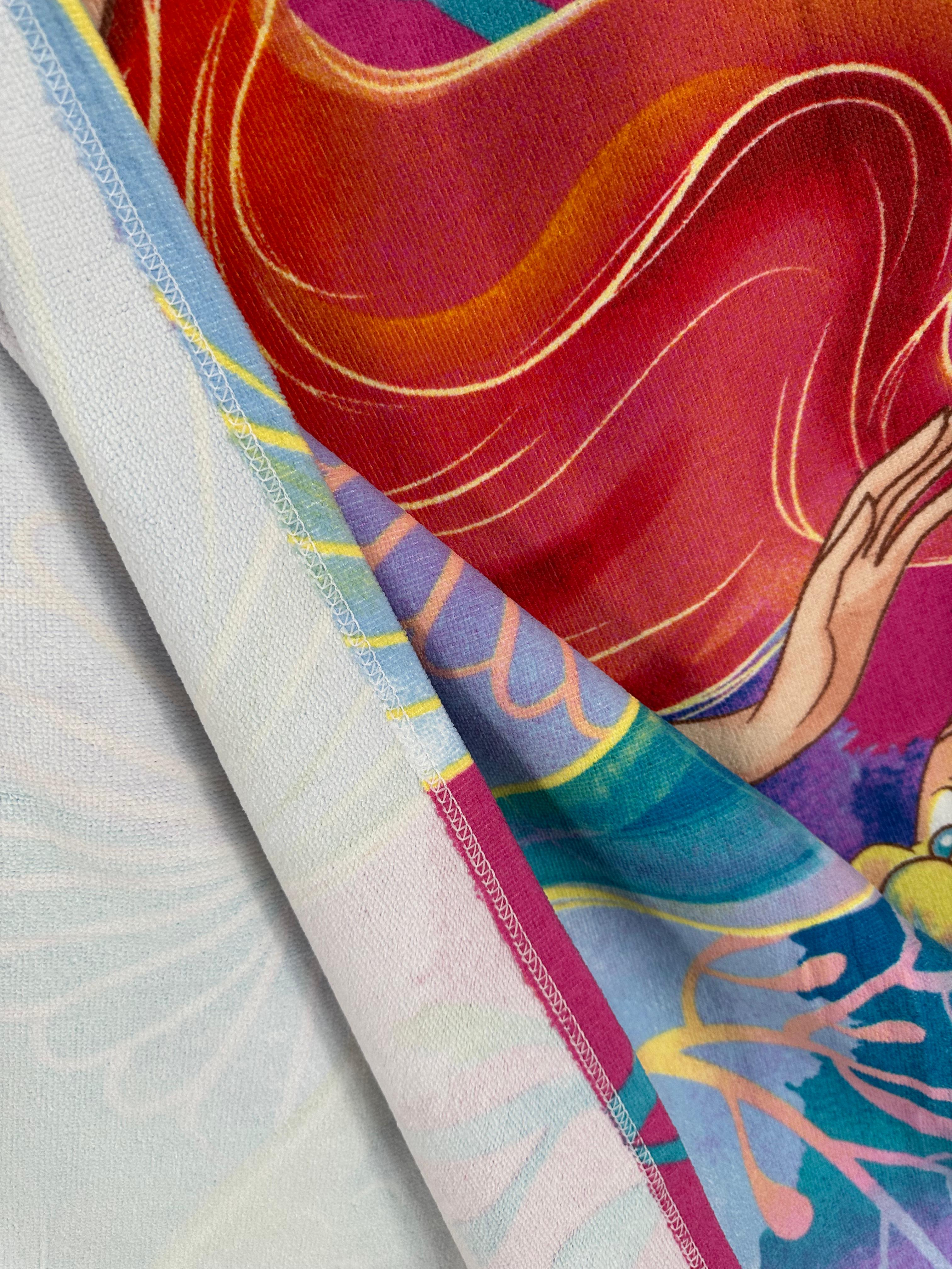 Close-up of colorful fabric with abstract patterns and a hand design.
