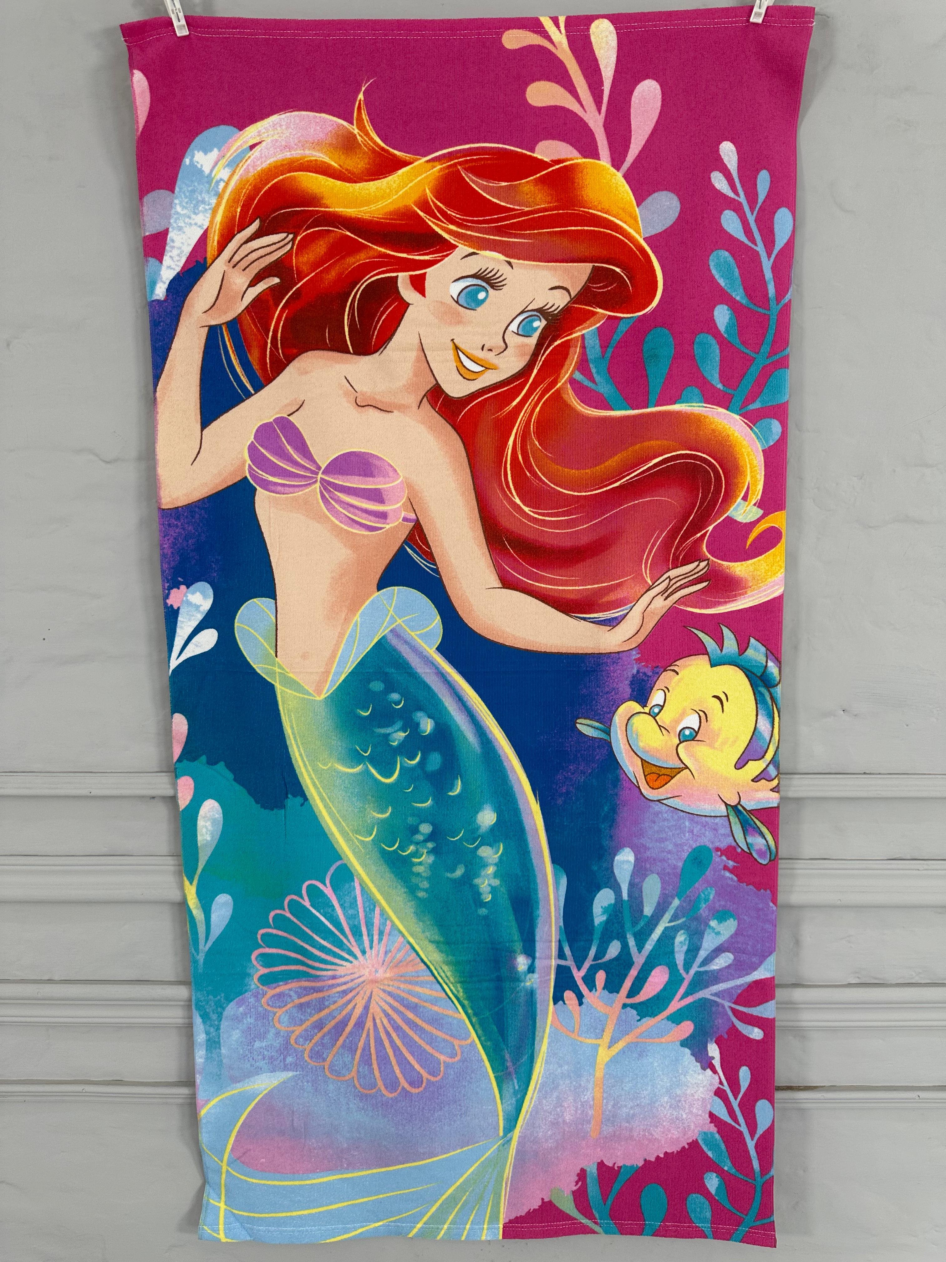 Towel with a mermaid design on a pink background