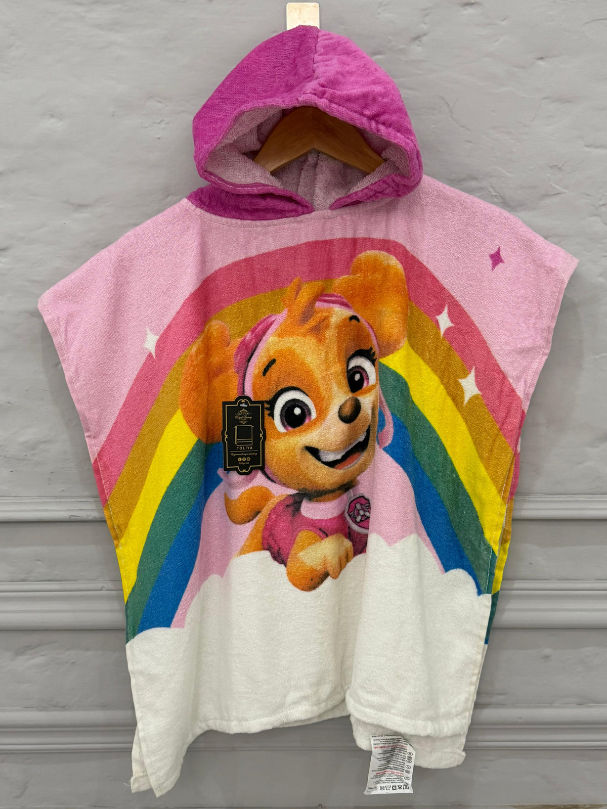 Children's hooded towel with cartoon character and rainbow design on a gray background