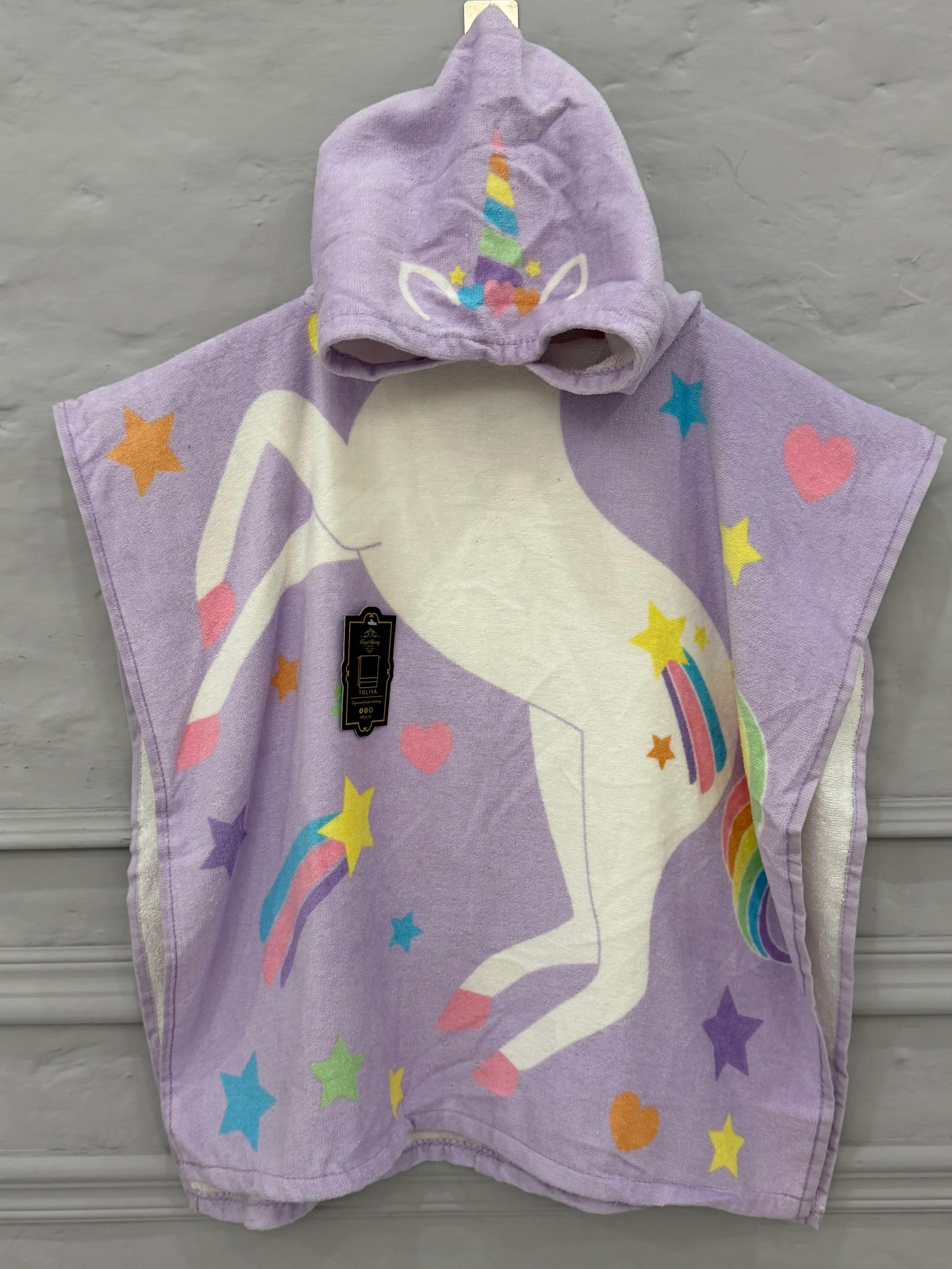 Purple unicorn hooded towel with colorful designs on a gray background