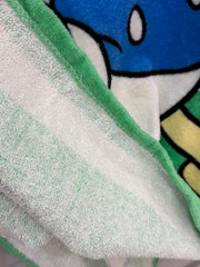 Close-up of a green and white towel with cartoon character in the background