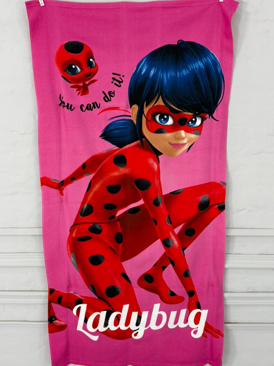 Towel with Ladybug character and text on a pink background