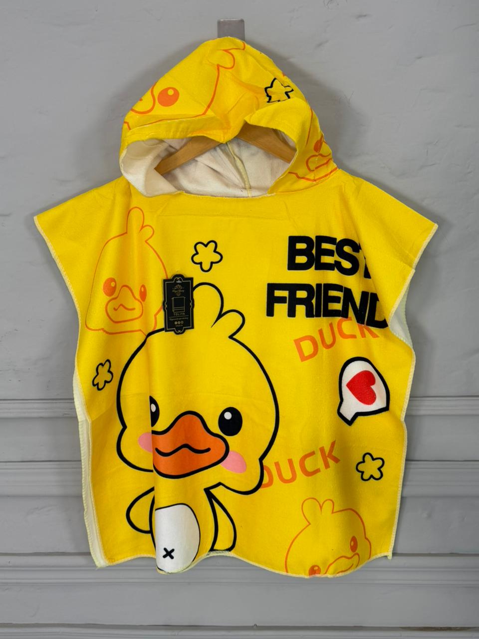 Yellow children's poncho with duck design and text on a gray background