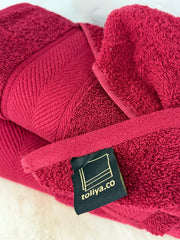 Red towel with a visible brand tag on a white background