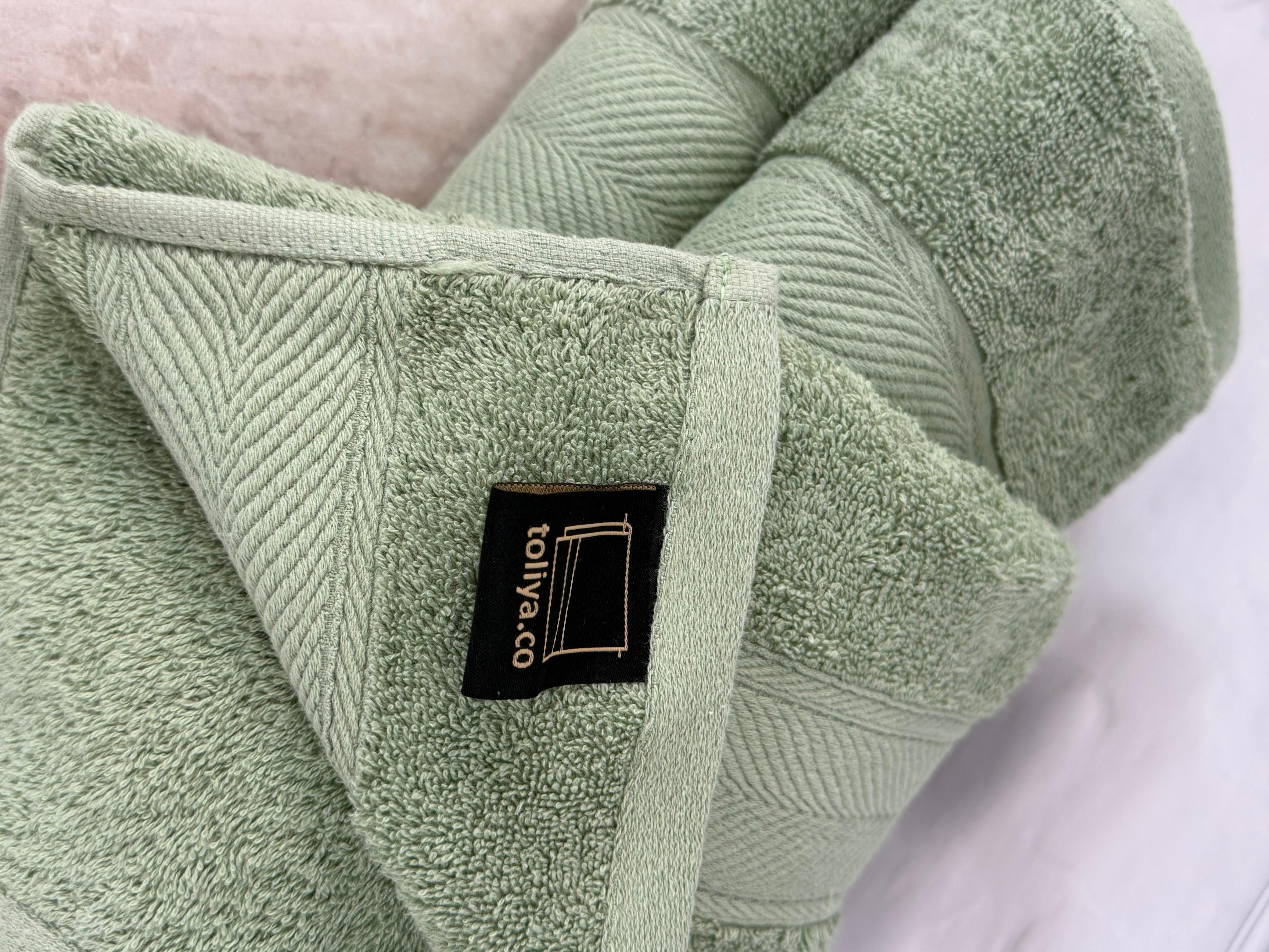 Green towel with a brand label on a white background