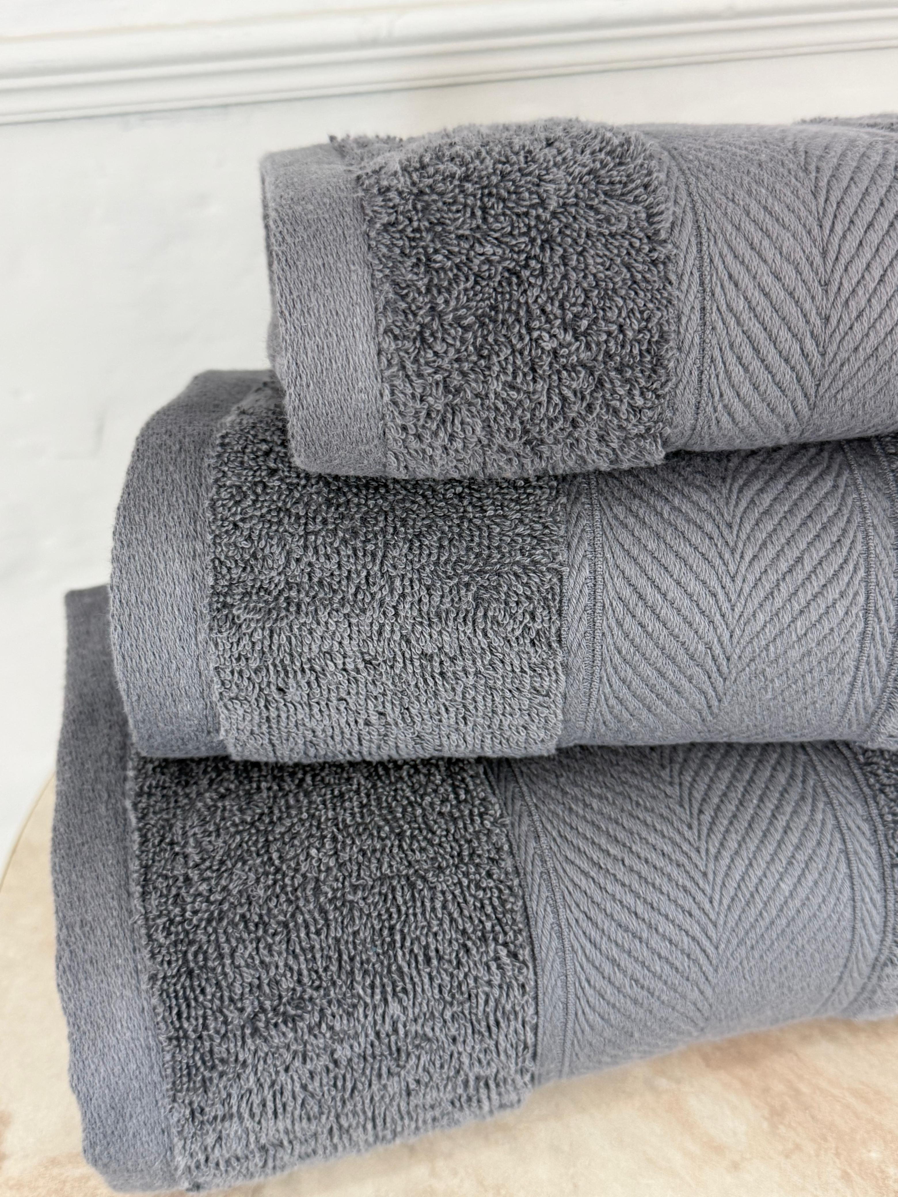 Stack of gray towels on a white surface