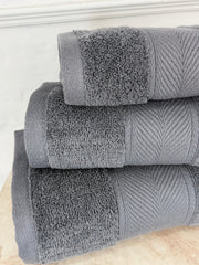Stack of gray towels on a white surface
