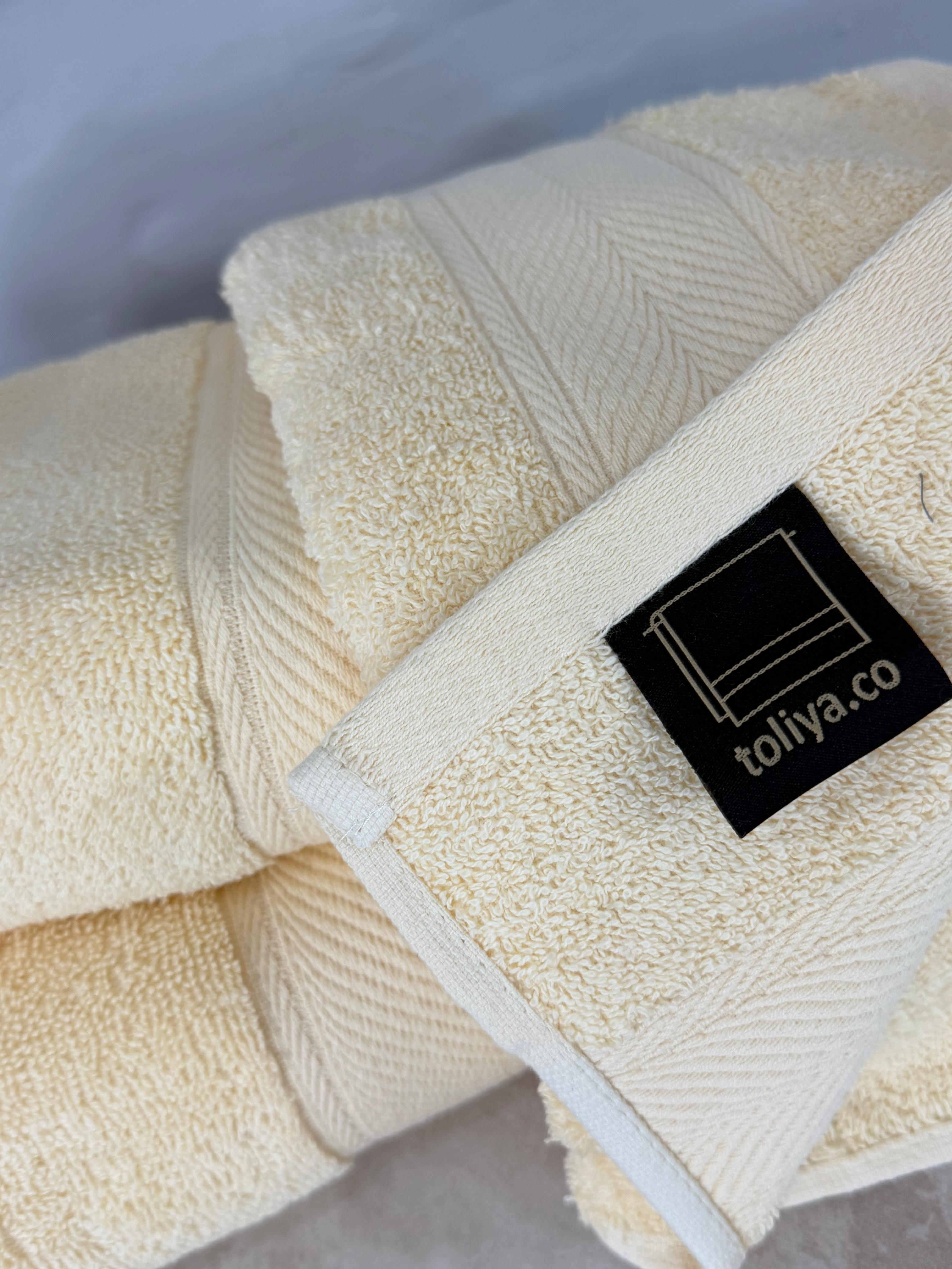 Beige towel with a black label on a gray background