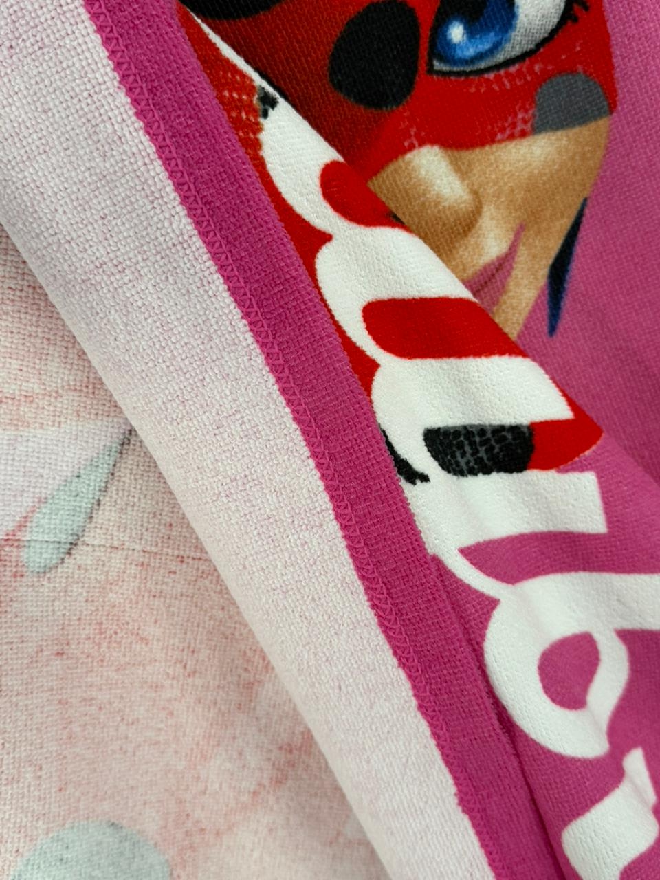 Close-up of a cartoon character on a pink background with visible text.