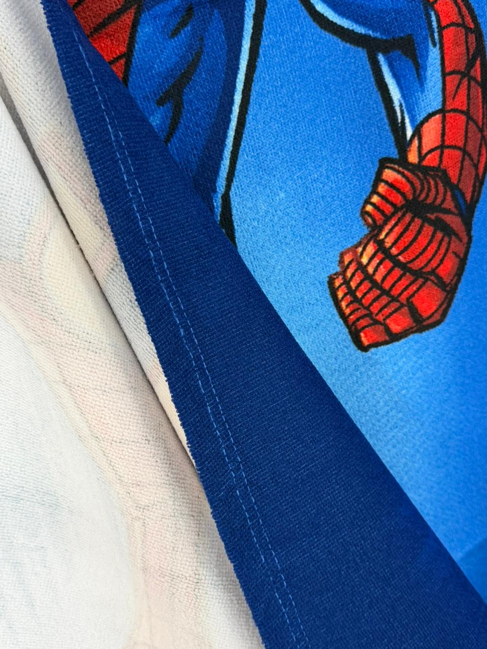 Close-up of a superhero costume with blue suit and red accents on a white background