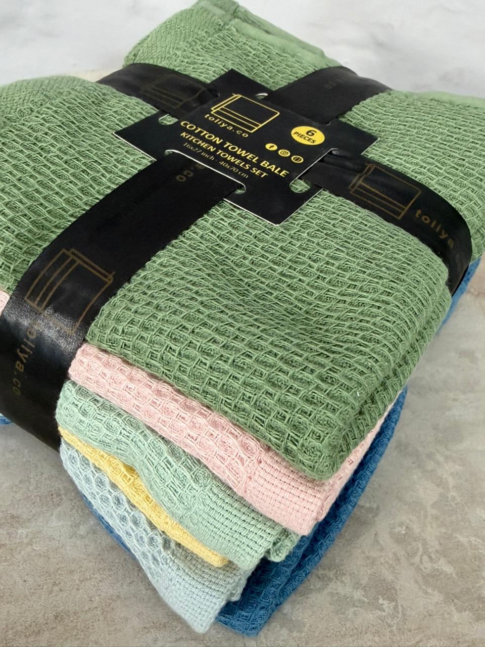 Set of folded towels with a label on a textured surface