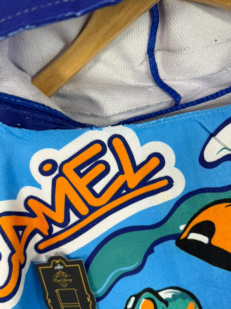 Close-up of a blue and orange Camel branded product with a wooden tool.